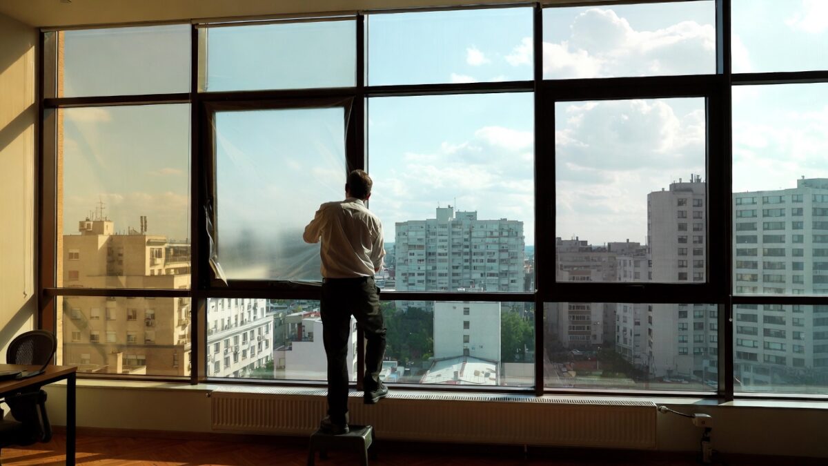person installing commercial window film image